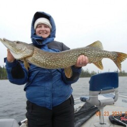 woman holding up fish she caught